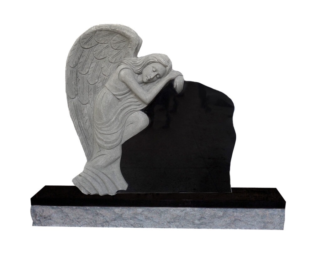 Grieving Angel 3 Gravestone featuring a sorrowful angel sculpted in gray stone, resting against a polished black memorial. Surrounded by grassy landscape, symbolizes remembrance.
