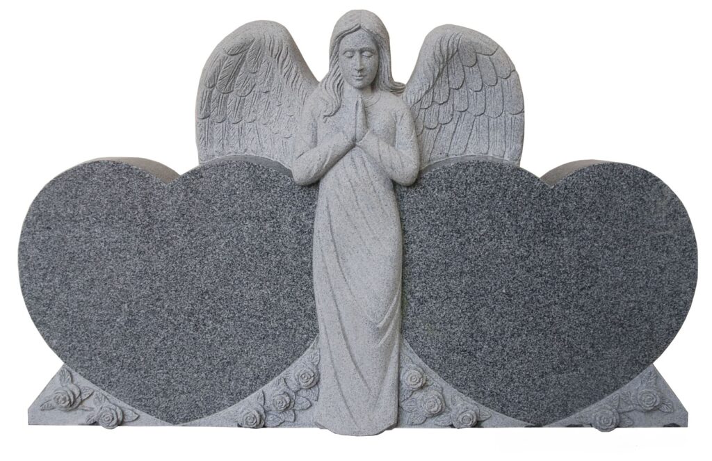 Praying Angel Double Heart Stone angel with folded hands stands between two heart-shaped gravestones, adorned with roses, symbolizing love and remembrance.
