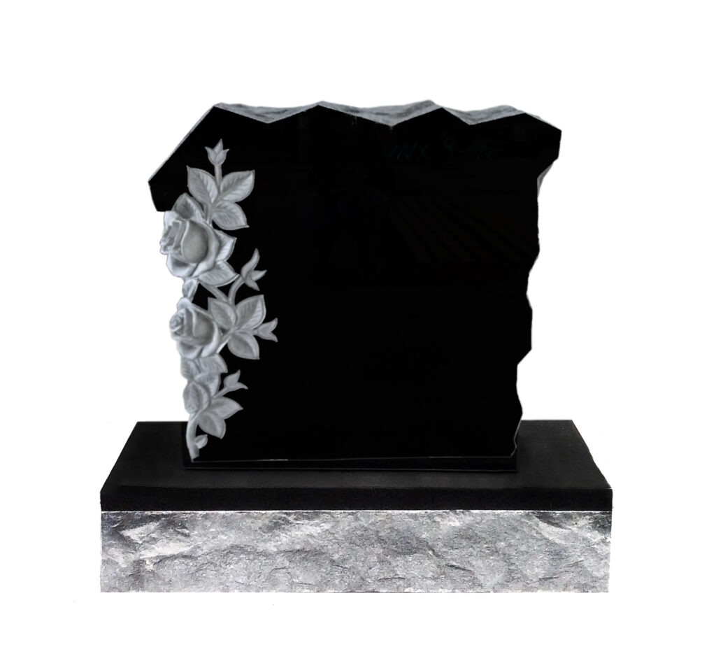 Rock with flowers Black granite headstone with intricately carved white roses, set on a textured gray base. Represents remembrance and tribute.