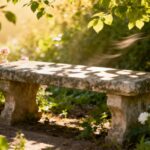Peaceful garden with stone bench and flowers.